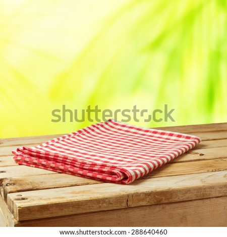 Summer nature background with wooden table and tablecloth