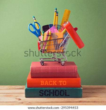 Back to school concept with shopping cart on books