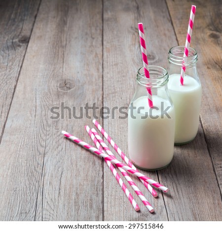Milk bottles with retro striped straws