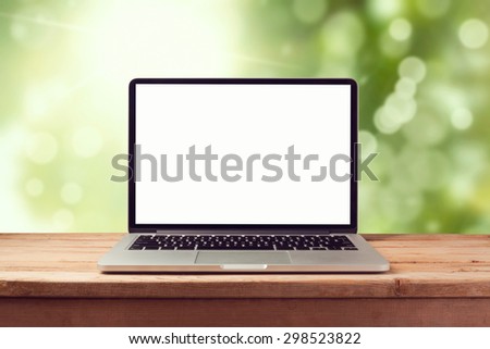 Laptop computer mock up over nature bokeh background. Retro filter effect