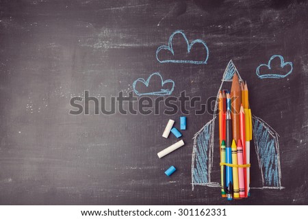 Back to school background with rocket made from pencils. View from above