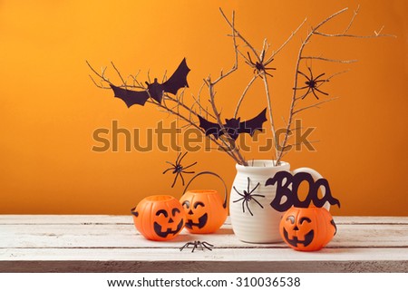 Halloween home decorations with spiders and pumpkin bucket for trick or treat