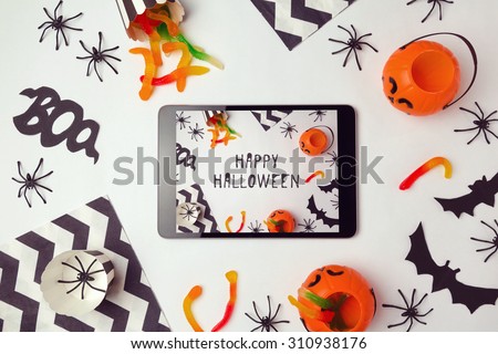 Halloween holiday background with digital tablet and decorations