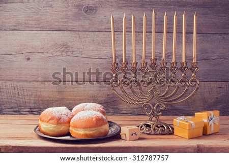 Jewish holiday hanukkah celebration with vintage menorah over wooden background
