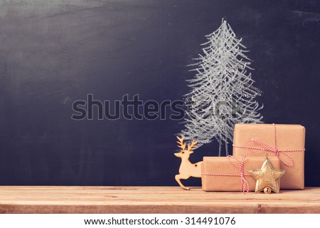 Christmas background with chalkboard and presents.Retro filter effect