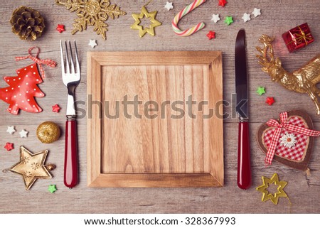 Wooden empty plate with rustic Christmas decorations. Menu background