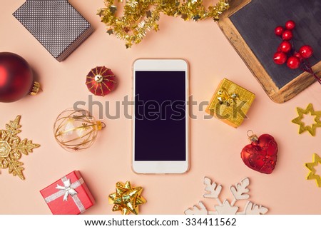 Smartphone with Christmas decorations. Christmas mock up template. View from above