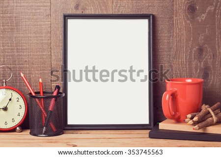 Poster mock up template with business desk objects over wooden background