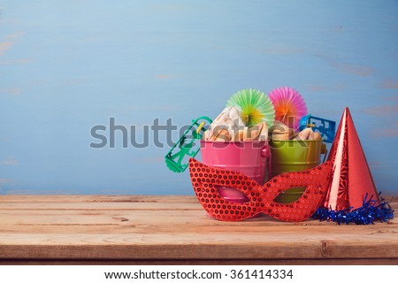 Jewish holiday purim background with carnival mask, hat and buckets