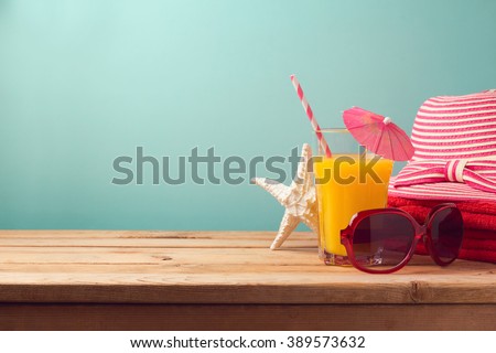 Summer holiday vacation concept with orange juice and beach items
