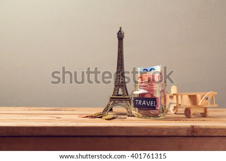 Travel to Paris, France concept with Eiffel Tower souvenir and wooden airplane toy. Planning summer vacation, money budget trip concept.