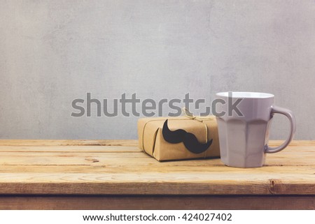 Coffee cup and gift box on wooden table. Father\'s day holiday concept