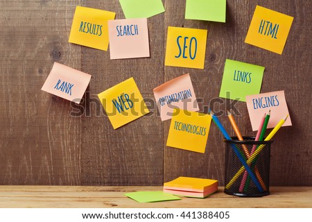 Search engine optimization SEO concept with notes on wooden wall