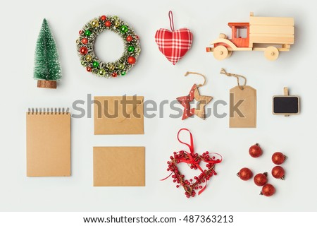 Christmas decorations and objects for mock up template design. Notebook, toy truck and wreath. View from above. Flat lay