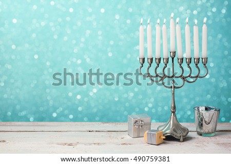 Jewish holiday Hanukkah celebration with menorah, dreidel and gifts on wooden table