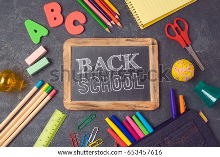 Back to school background with chalkboard and school supplies.View from above. Flat lay