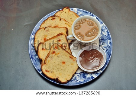 Breakfast of coffee and slices bread with chocolate