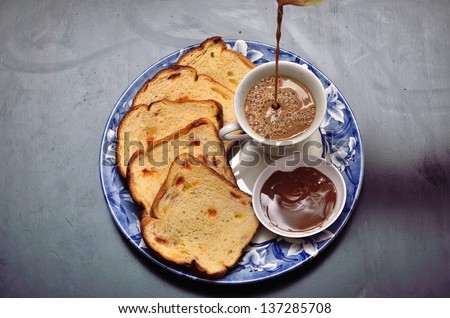 Breakfast of coffee and slices bread with chocolate
