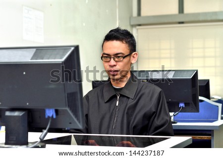 Young man doing his works at personal computer