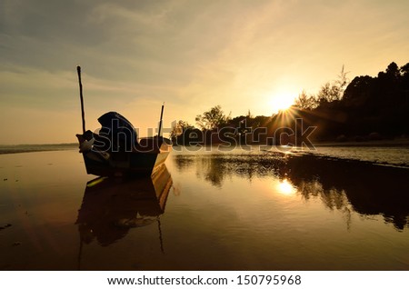 Boat near the beach at sunset