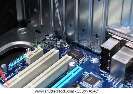 Close-up of technician's hand assembling personal computer