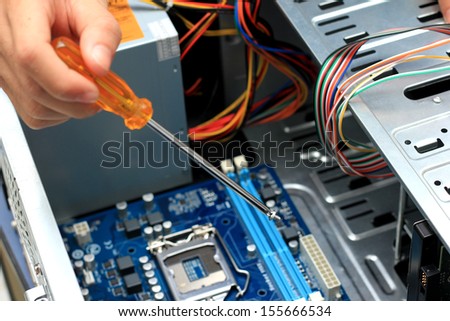 Close-up of technician\'s hand assembling personal computer