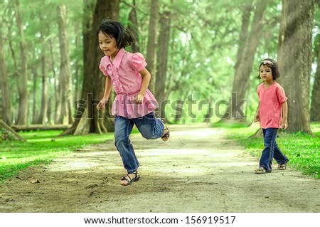 Two kids playing at the park (blurry on main character because of movement and motion jumping)