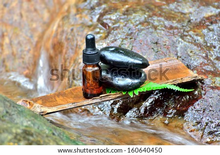 Zen stone with spa oil in SPA concept at waterfall