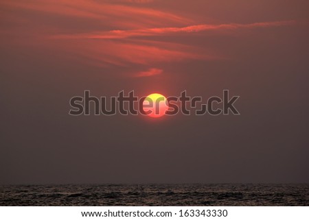 morning sun hangs over the sea
