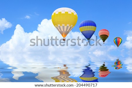 Hot air balloon floating in the sky with water reflection