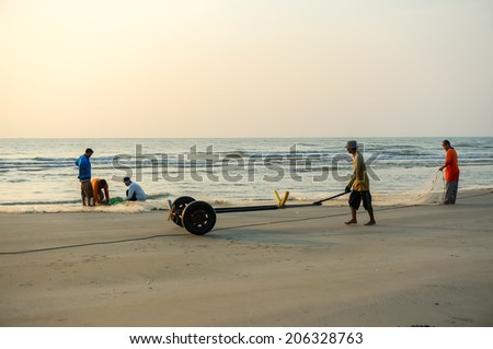 KUANTAN, MALAYSIA - JULY 20, 2014 - Fishermen do their work near Beserah beach, Kuantan, Malaysia at July 20, 2014. Fishermen are the main occupation for villagers at Kuantan village, Pahang
