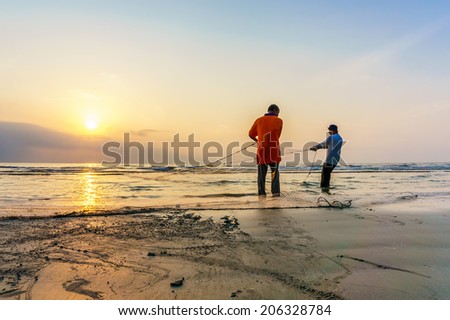 KUANTAN, MALAYSIA - JULY 20, 2014 - Fishermen do their work near Beserah beach, Kuantan, Malaysia at July 20, 2014. Fishermen are the main occupation for villagers at Kuantan village, Pahang