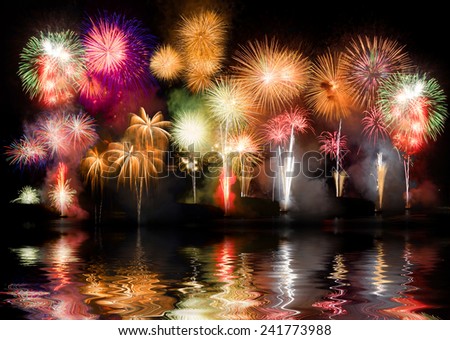 Colorful fireworks. Fireworks are a class of explosive pyrotechnic devices used for aesthetic and entertainment purposes. Visible noise due to low light, soft focus, shallow DOF, slight motion blur
