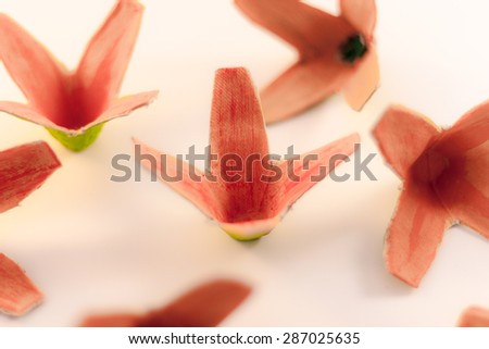 Set of handmade pink paper flowers on white background. Selective focus on middle flower.