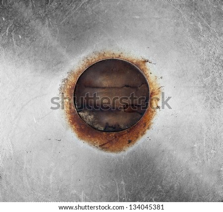 Vintage or grunge steel background with rounded rusted center and scratches. Steam punk or industrial style.
