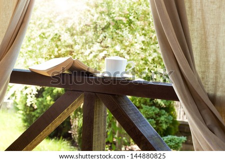 Book And Coffee In The Garden Terrace - Peaceful Weekend Morning Concept