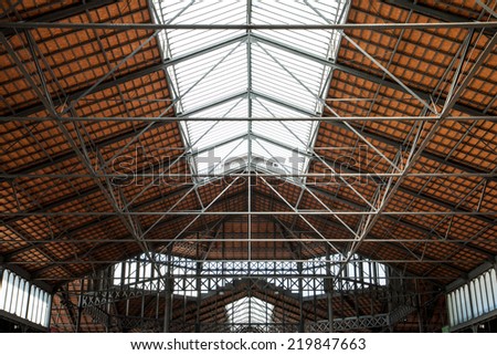 Industrial building interior - steel framework of roof with skylights. Construction and modern architecture design.