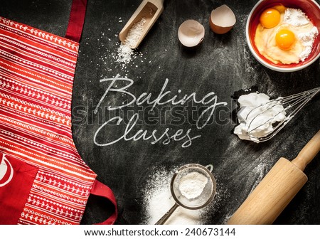 Baking classes poster design with cake ingredients on black chalkboard from above. Apron, bowl, flour, eggs, egg whites foam, eggbeater, rolling pin and eggshells.