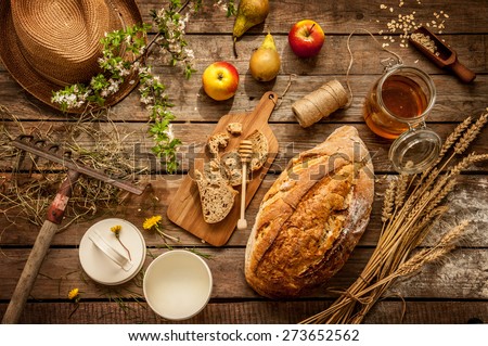 Natural local food products on vintage wooden table - rustic composition captured from above. Country lifestyle, rural vacation or agritourism concept.