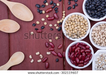 Soy beans, Red beans, black beans, and navy bean on dark wooden background