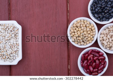 Jobs tears, Soy beans, Red beans, black beans, and navy bean on dark wooden background
