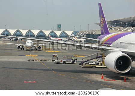 BANGKOK, THAILAND-MARCH 24: An aircraft parking at Suvarnabhumi Airport, on 24 March 28, 2014 Airport, designed by, Helmut Jahn is the world\'s third largest single-building airport terminal