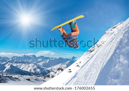 Extreme snowboarder jumping high in the air