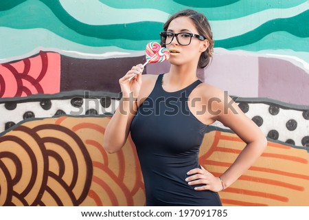 Sexy girl with lollipop. Sexy caucasian young woman licking candy stick