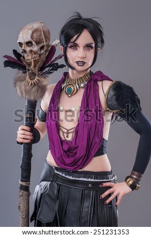 Dark gothic woman. Sexy gothic woman posing with skull.