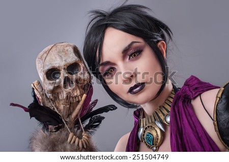 Dark gothic woman. Sexy gothic woman posing with skull.