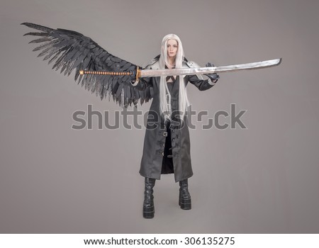 Fantasy woman warrior. Woman warrior with sword and wings isolated on the gray background