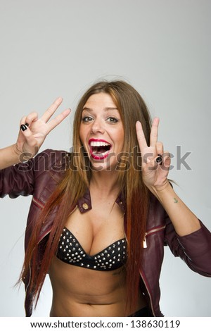 Young attractive biker girl crazy funny, cute expression on white background