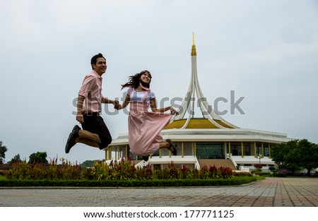 Lovely couple jump up together2