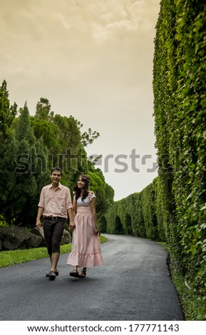 Lovely couple walk together in the garden2
